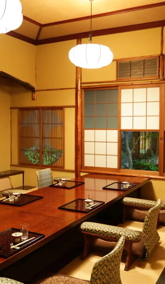 A private tatami room at Tsukiji Jisaku with a sunken table and shoji screens onto the garden